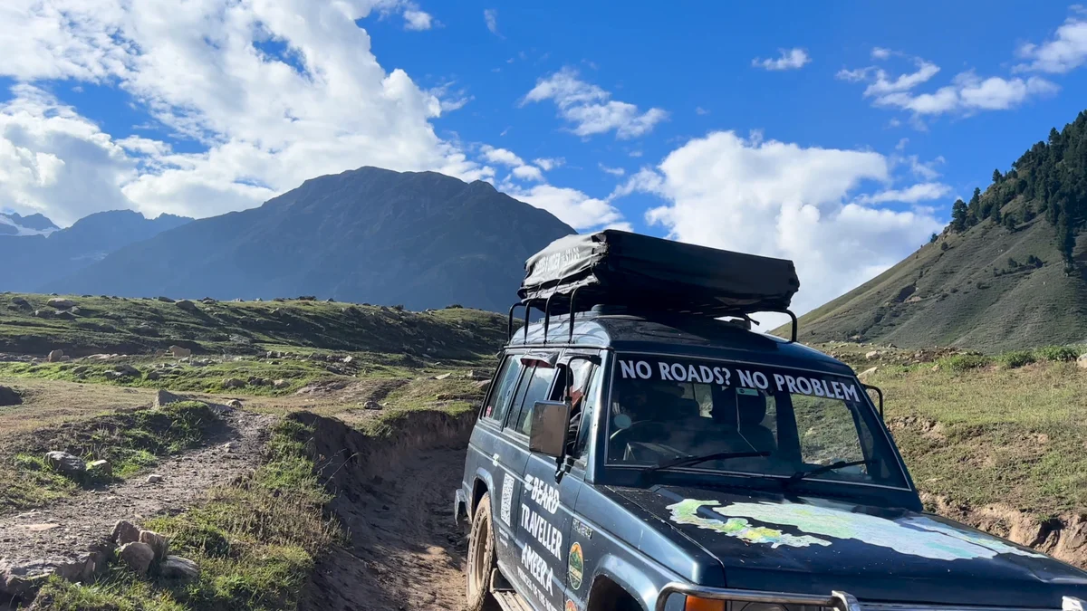 A close view of Ameera and her packed rooftop tent on a rocky mountain track